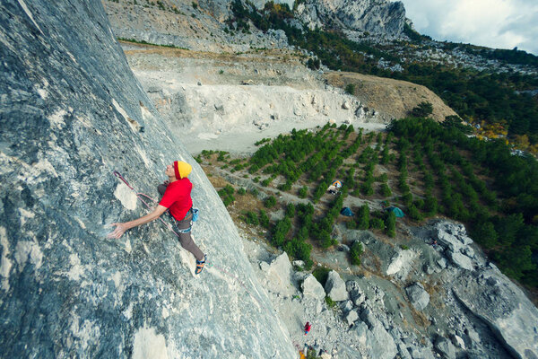 A man climbs the rock.