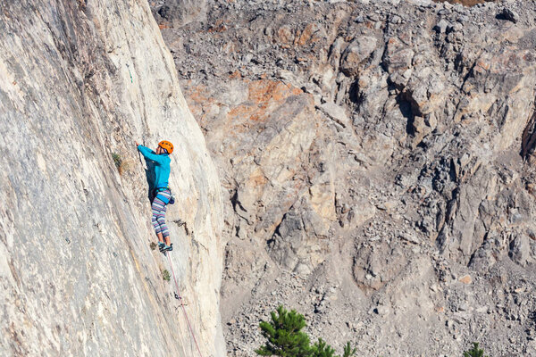 The girl climbs the rock.