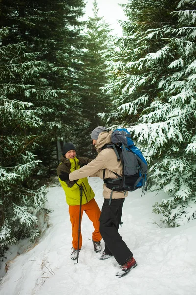 Man helping friend to climb.