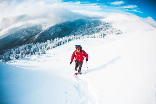Ένας άνθρωπος με χιονοπέδιλα στα βουνά. — Φωτογραφία Αρχείου