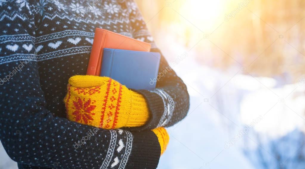 Books on the background of knitted sweaters.