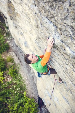 Bir dağcı bir kayanın üzerinde.