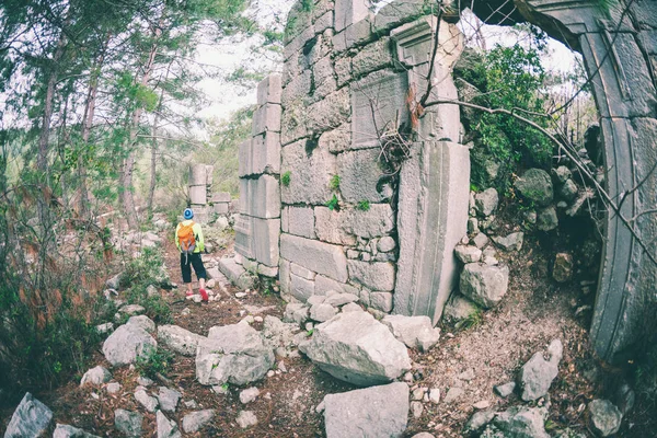 A man looks at ancient ruins.