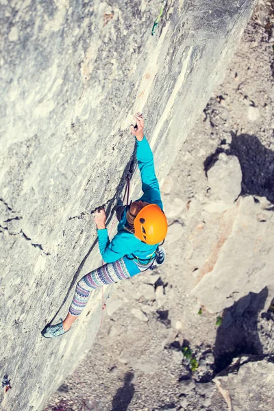 Het meisje klimt de rots. — Stockfoto