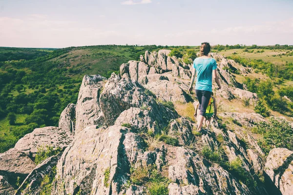 Girls with a backpack walk in picturesque places.