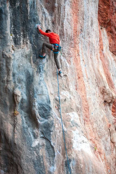 Un hombre sube a la roca . — Foto de Stock