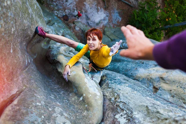 Rock-climber gives five.