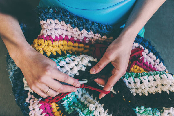 The woman is crocheting.