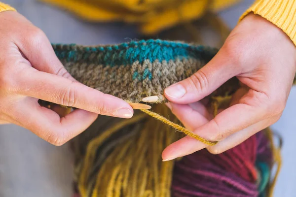 Young woman is knitting.