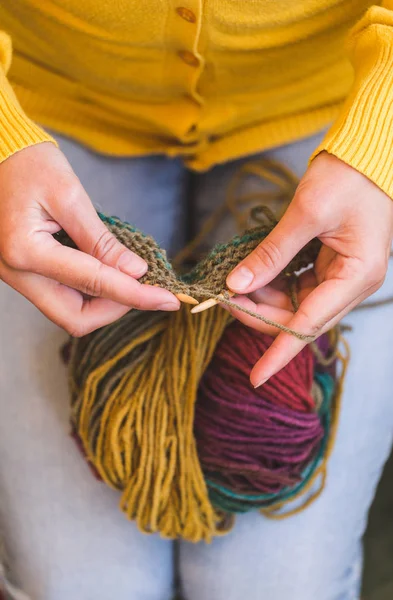 Young woman is knitting.