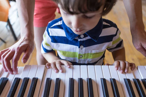 Children's and women's hands on the piano keys. — Stock Photo, Image