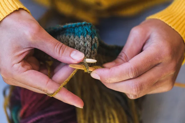 Young woman is knitting.