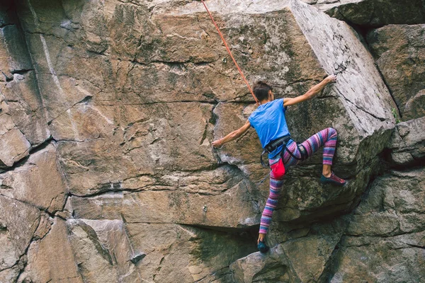 La ragazza sale sulla roccia di granito . — Foto Stock