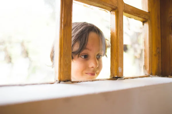 Curious Boy Looks Out Window Child Peeps House Window Playful — Stock Photo, Image