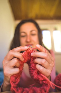 Kadın yatakta yatarken örgü örüyor, kadın elleri kapalı karantina, el yapımı, favori ev yapımı hobileri sırasında yaratıcılıkla meşgul..