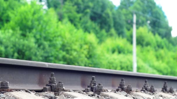 Railroad rail and a train passing on the background — Stock Video