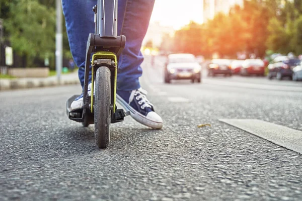 İşlek cadde boyunca tekme scooter sürme kadın