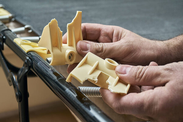 Man showing broken plastic bed slat holders