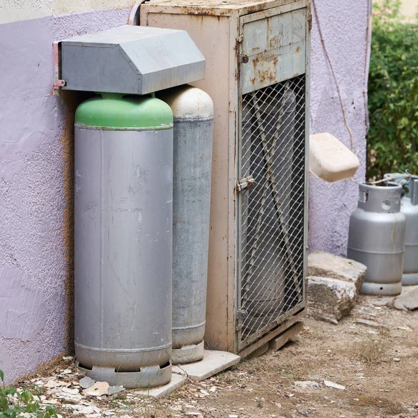 Cilindros de gás em pé perto de uma casa de habitação parede ao ar livre em Israel — Fotografia de Stock