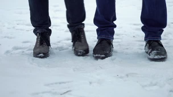 Füße von Menschen, die vor Kälte frieren und sich von Fuß zu Fuß bewegen — Stockvideo