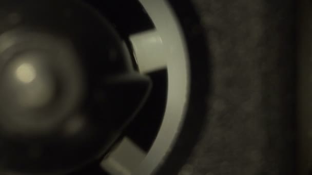 Half of a reel of a vintage audio cassette macro rotating in the tape recorder — Stock Video