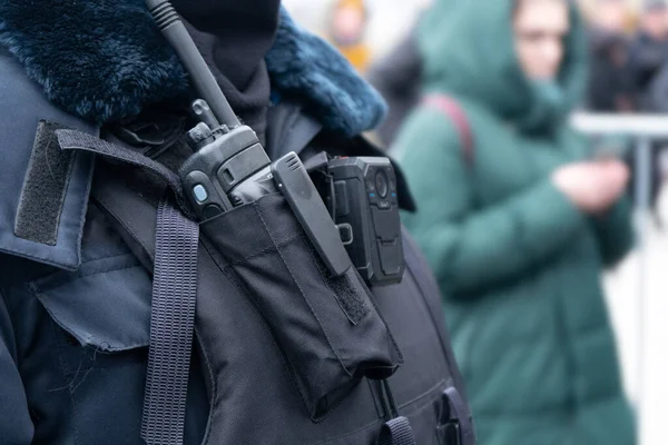 Police radio device on the chest of a russian policeman close up on the street. Police communication tool