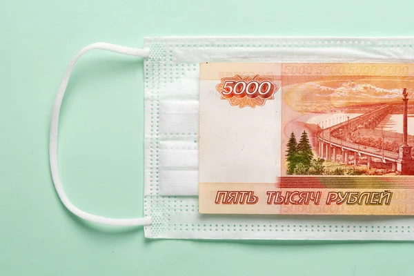 Medical mask with Russian money lying on it. — Stock Photo, Image