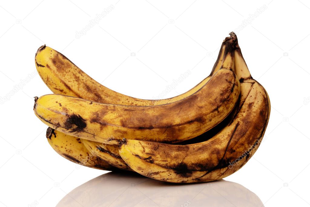 Bunch of over ripe bananas isolated on the white background with a reflection