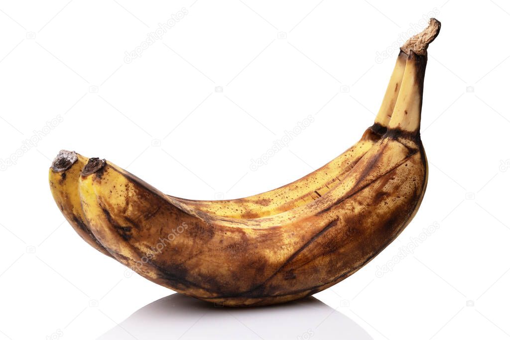 Over ripe bananas isolated on the white background with a reflection