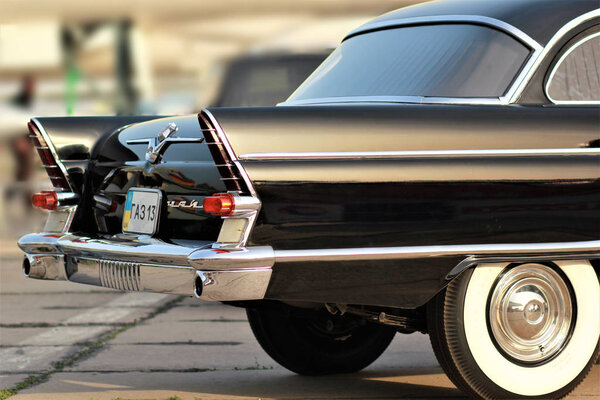 Vintage soviet black car Chaika, rear part at the Old Car Land Festival