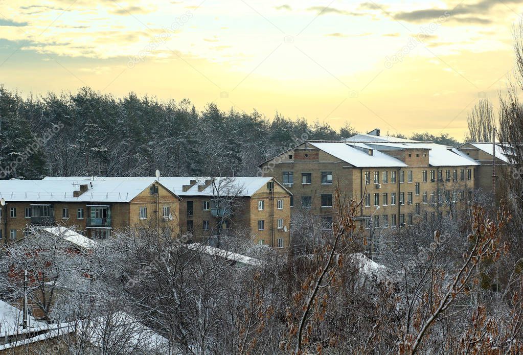Typical ukrainian Khrushchyovkas -  type of low-cost, brick five-storied apartment building, developed in Soviet Union during 1960s. Winter sunrise Bucha town