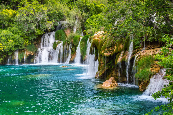 Krka Waterfalls in Krka National Park, Croatia. Skradinski buk is the longest waterfall on the Krka River with clear water and dense forest. Long exposure