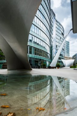 Frankfurt am Main, Almanya 'nın merkezindeki modern mimari kompleksi. Dalgalar şeklinde, kemerli cam bina ve suyla dolu bir gölet.