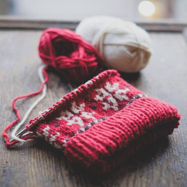 Bitmemiş örme kap örgü iğneleri ahşap zemin üzerinde