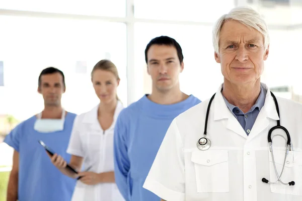 Medical team at the hospital - Doctors and nurse standing in a row - Portrait at work