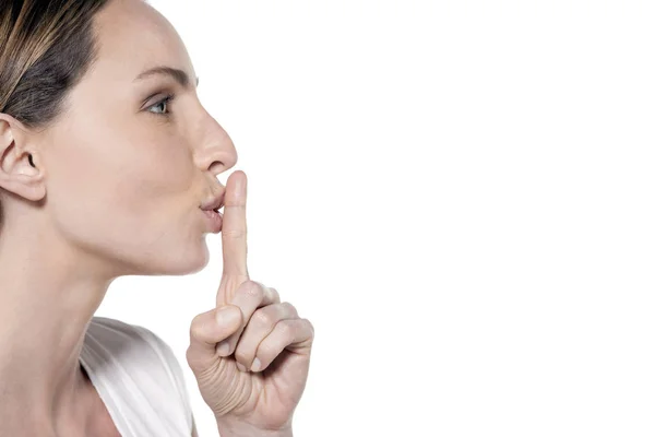Happy woman with finger on lips — Stock Photo, Image