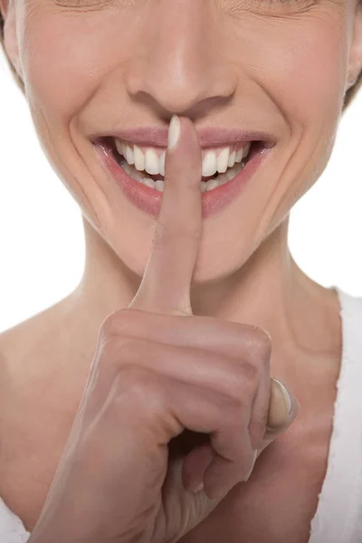 Happy woman with finger on mouth — Stock Photo, Image
