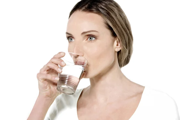 Молода жінка п'є склянку води — стокове фото