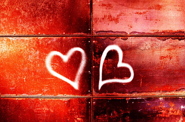 the drawing of two hearts on a red wall for Valentine 's Day
