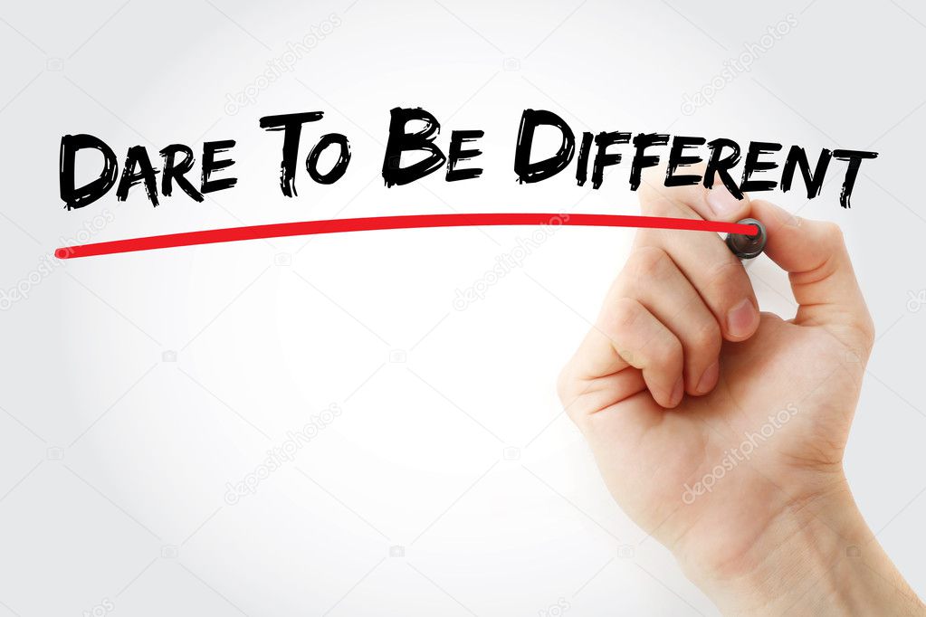 Hand writing Dare To Be Different with marker