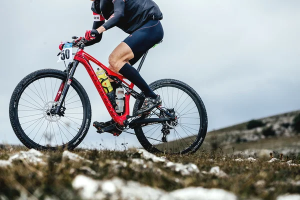 closeup male cyclist mountainbiker sports bike ride on a mountain trail