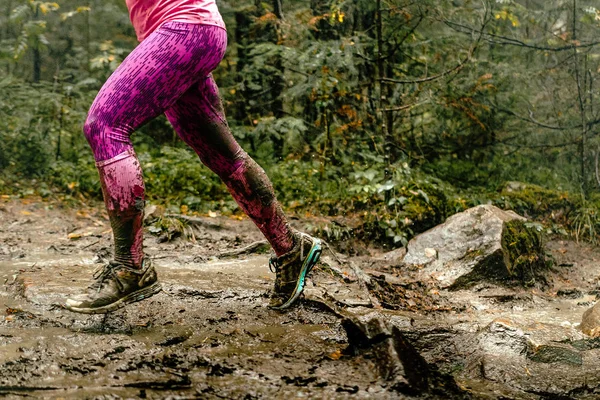 woman runs over rocks