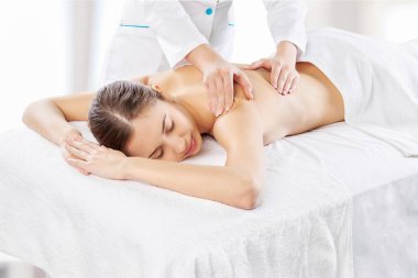 Woman relaxing with massage clipart