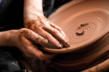 hands of potter making clay pot  clipart