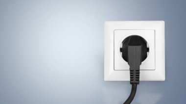 white electrical plug in the electric socket  clipart