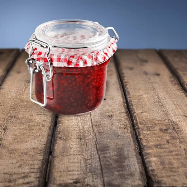 Glass jar with raspberry jam — Stock Photo, Image