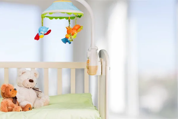 Baby cot with toys — Stock Photo, Image