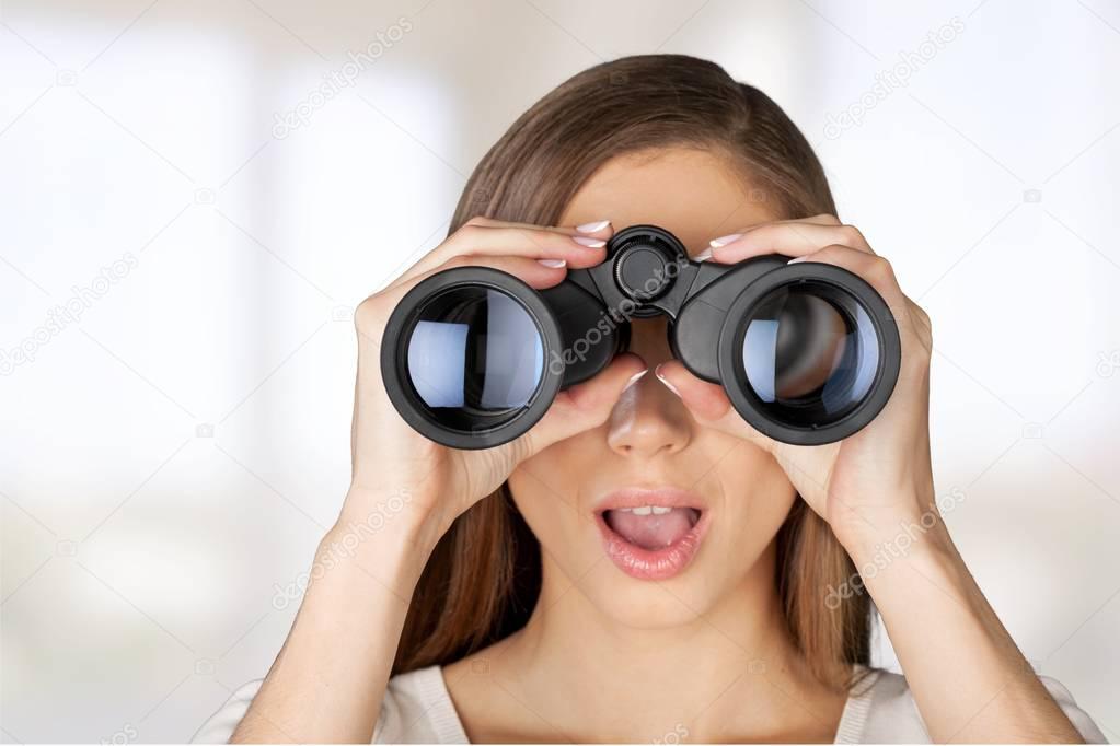 Girl looking into binoculars