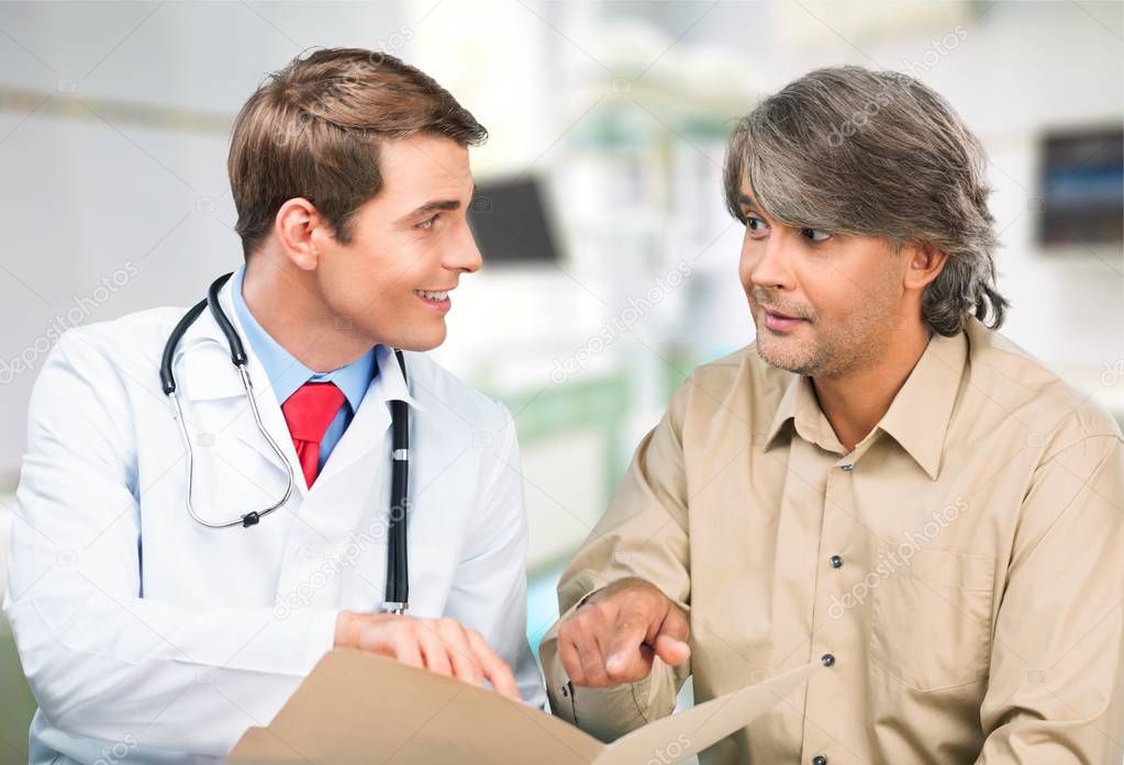 Handsome doctor with male patient 