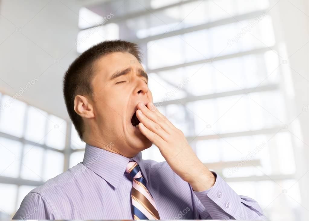 Tired, Yawning young businessman